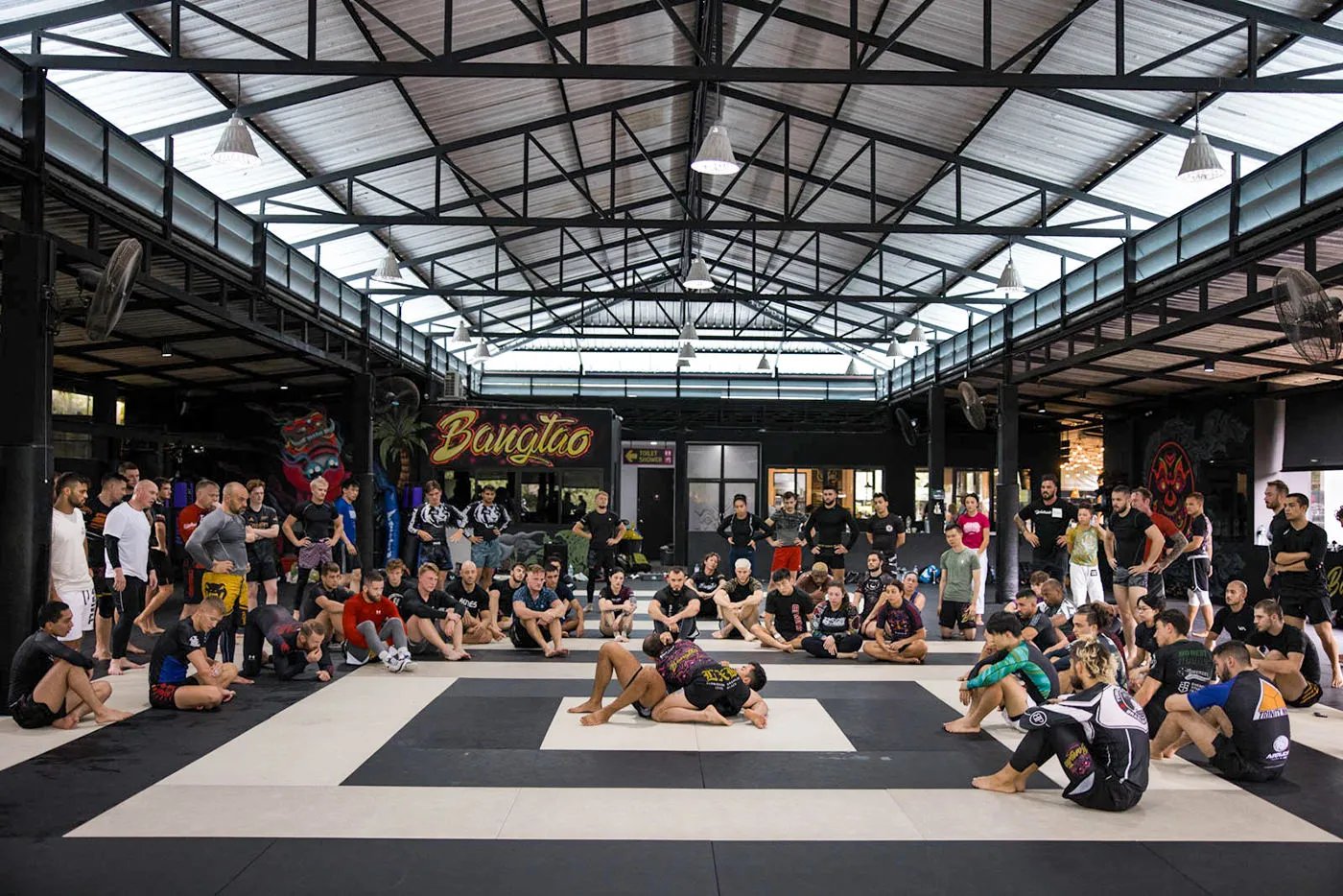 A seminar in progress on the mats at Bangtao Muay Thai & MMA